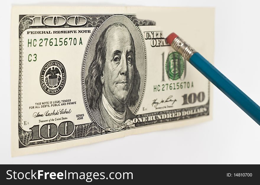 Erasing a 100 dollar bill with a blue pencil whith red eraser. Erasing a 100 dollar bill with a blue pencil whith red eraser