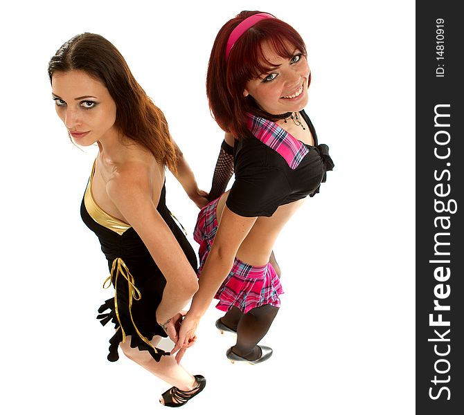 Two beautiful models dancing in a studio setting over white background. Two beautiful models dancing in a studio setting over white background.