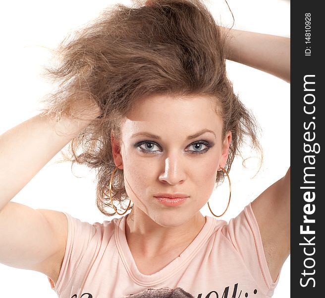 Young fashion model with her hands at her head. Isolated over white.