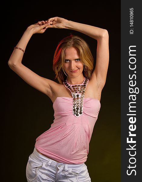 Young woman is dancing in a studio setting. Ideal for young lifestyle themes. Young woman is dancing in a studio setting. Ideal for young lifestyle themes.