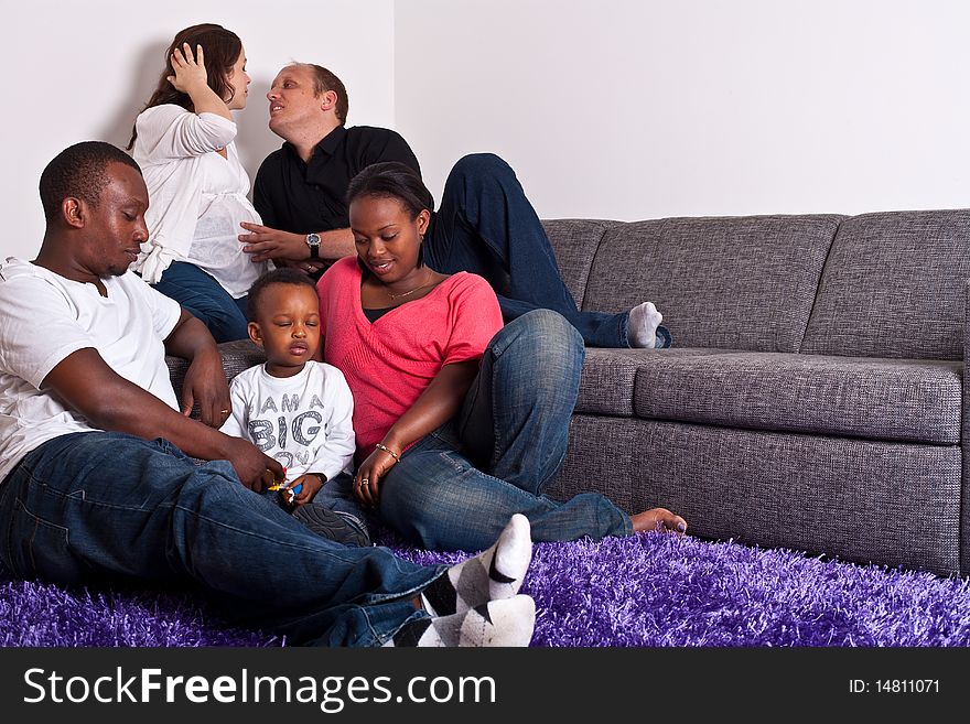 Young group of multiracial friends - two young families enjoying an afternoon together. Young group of multiracial friends - two young families enjoying an afternoon together.