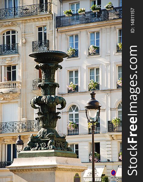 Fountain and lantern against the house in Paris