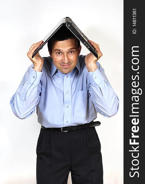 Smiling man with the laptop computer above the head on the white background