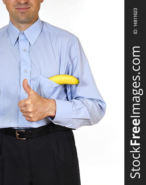 Man in the suit with the banana into pockets on the white background. Man in the suit with the banana into pockets on the white background