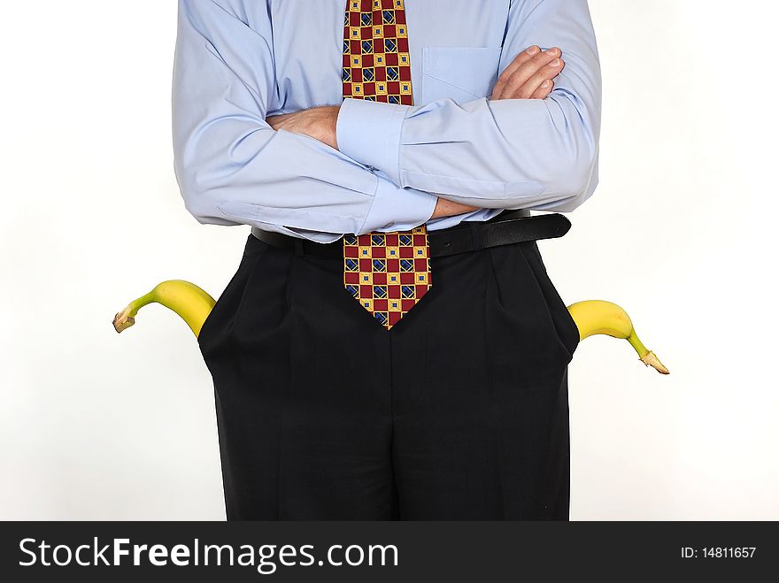 Man in the suit with the banana into pockets on the white background. Man in the suit with the banana into pockets on the white background