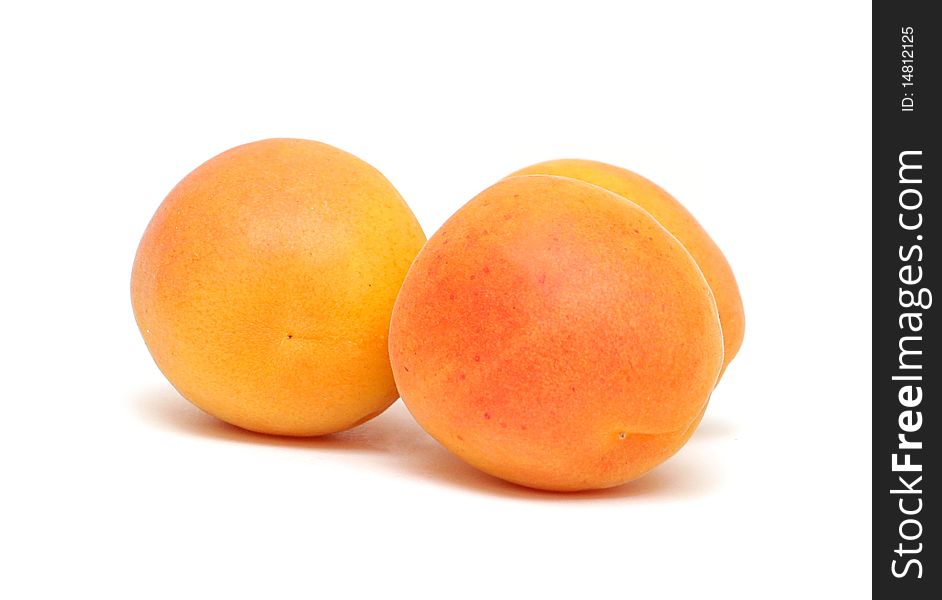 Three apricot isolated on white background