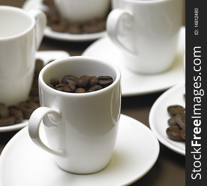 Still life of cups with coffee beans