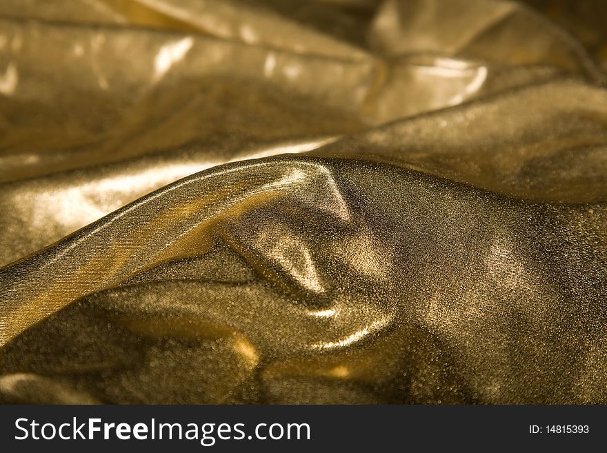 Close-up picture of elegant gold fabric fold. Close-up picture of elegant gold fabric fold