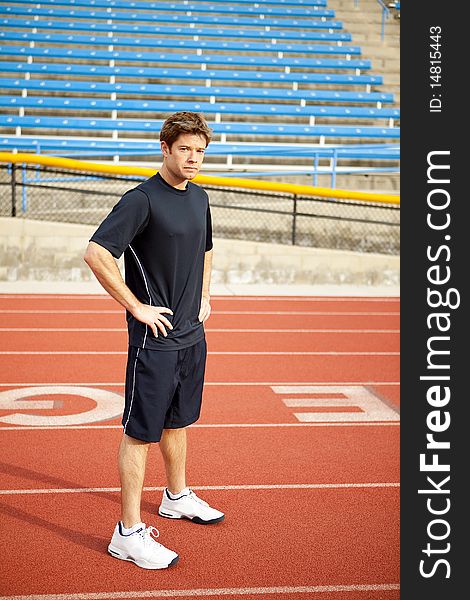 Man standing on a track outside. Man standing on a track outside