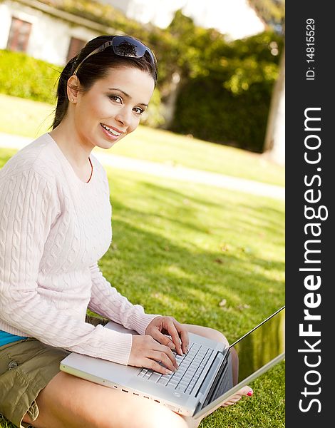 Young student using computer outside. Young student using computer outside