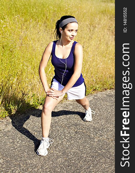 Young woman exercising outside in the sun