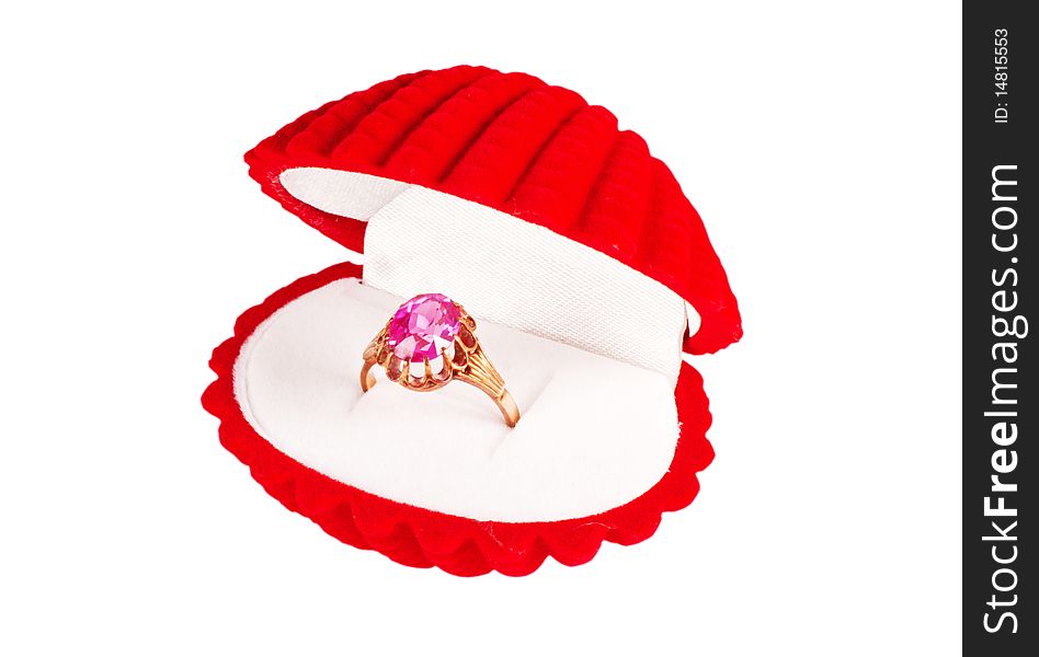 A red seashell box with golden ring