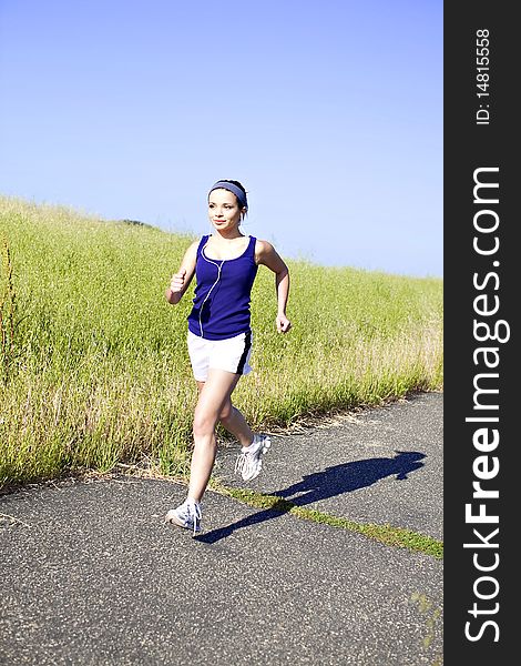 Young woman exercising outside in the sun