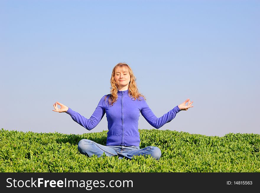 The young girl meditates in a spring field. The young girl meditates in a spring field