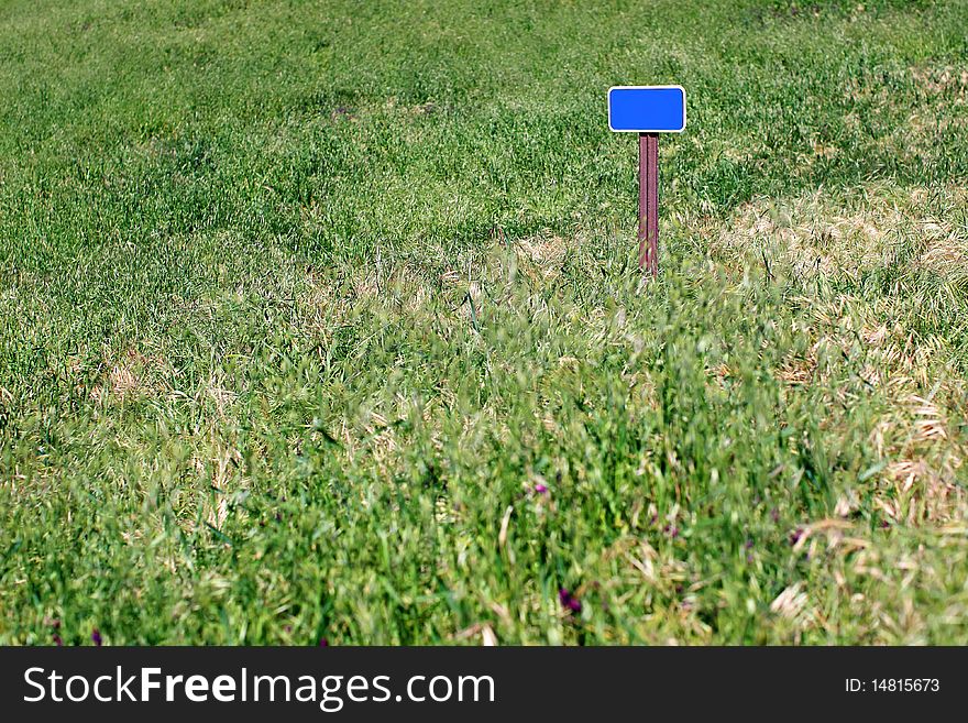 Blank sign in a grassy field