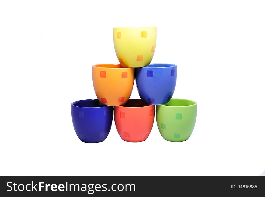 Isolated pyramid of six bright ceramic cups. Isolated pyramid of six bright ceramic cups