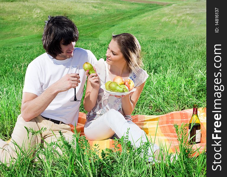Beautiful girl with fruits and boy with wineglass