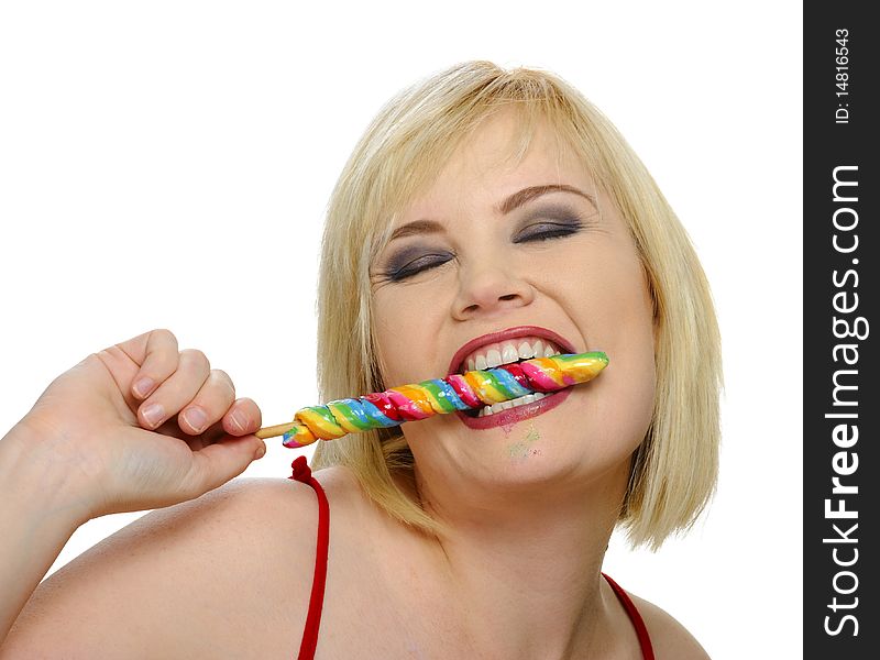 Pretty blond enjoys her multicolored candy stick. Pretty blond enjoys her multicolored candy stick