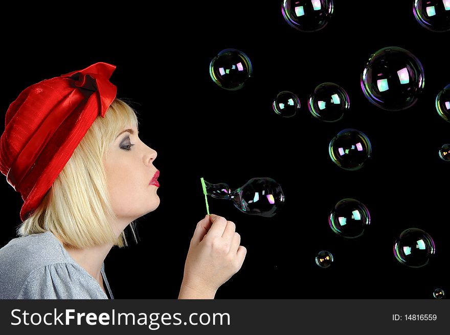Cute blond girl plays with bubbles in studio. Cute blond girl plays with bubbles in studio