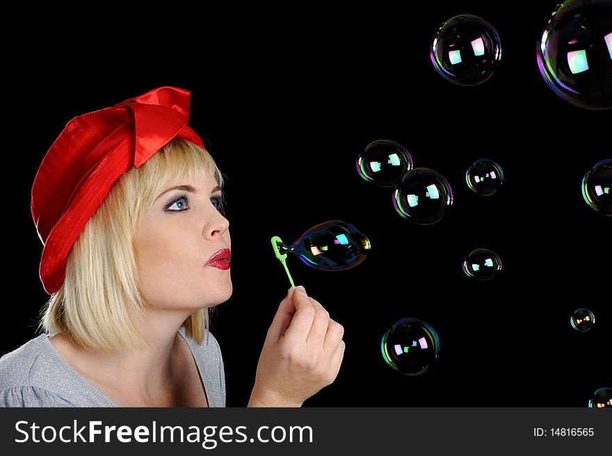 Cute blond girl plays with bubbles in studio. Cute blond girl plays with bubbles in studio