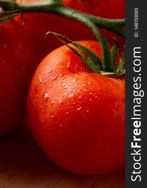 Tomato vegetables on wooden plate close up angle view