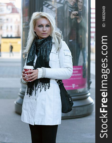 Young blond woman with drinking cup