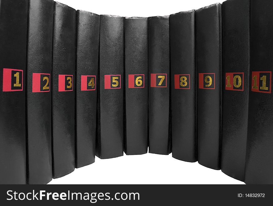 11 black books with the same golden colored numbers isolated on white background. 11 black books with the same golden colored numbers isolated on white background