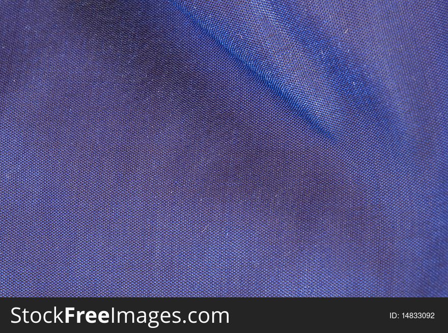 Blue silk with a mild crease can be used as background. Blue silk with a mild crease can be used as background