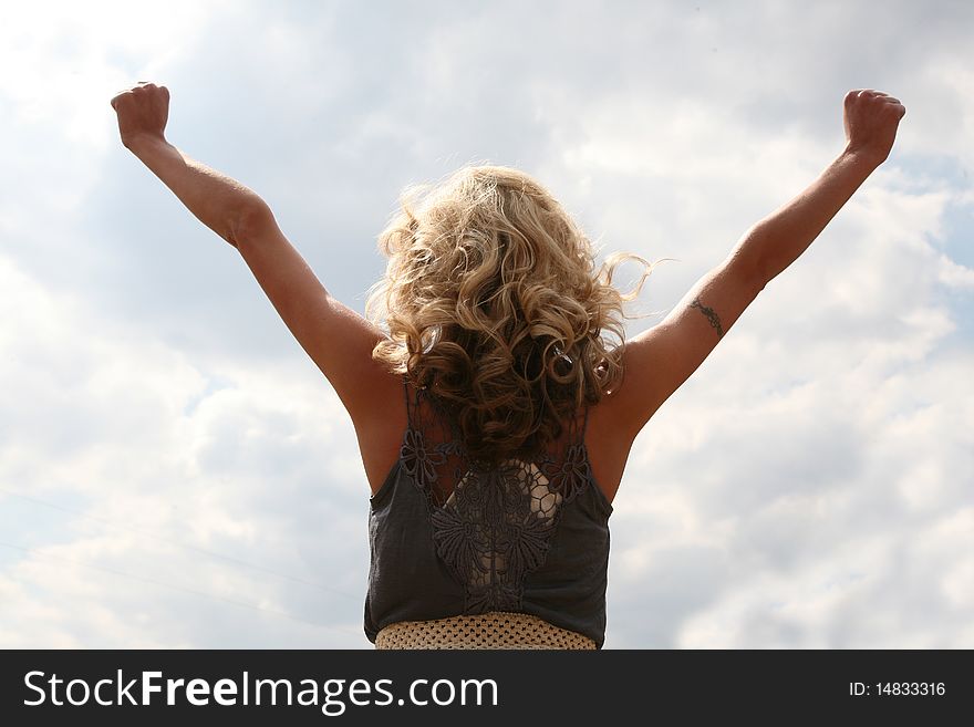 Woman holding her arms up outdoors