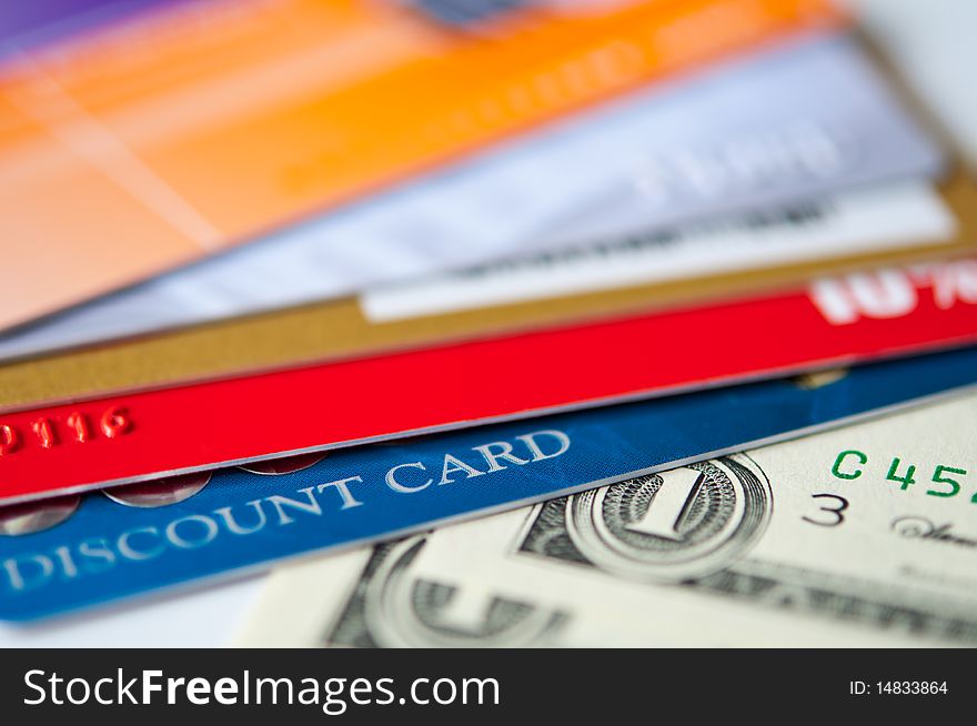 Bright plastic discount cards and usd money closeup. selective focus. Bright plastic discount cards and usd money closeup. selective focus.