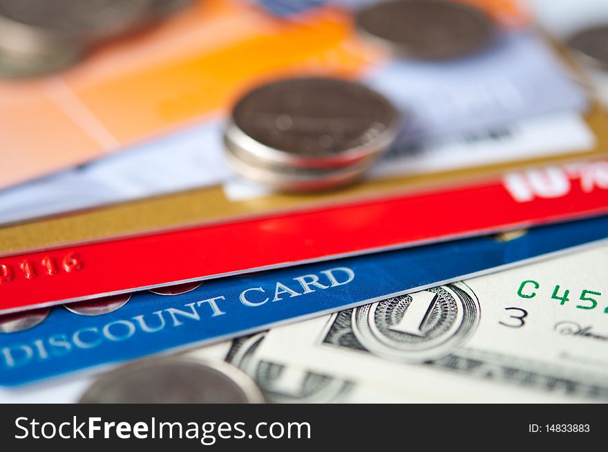 Bright plastic discount cards and usd money closeup. selective focus. Bright plastic discount cards and usd money closeup. selective focus.