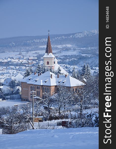 View about a village church dressed in snow. View about a village church dressed in snow