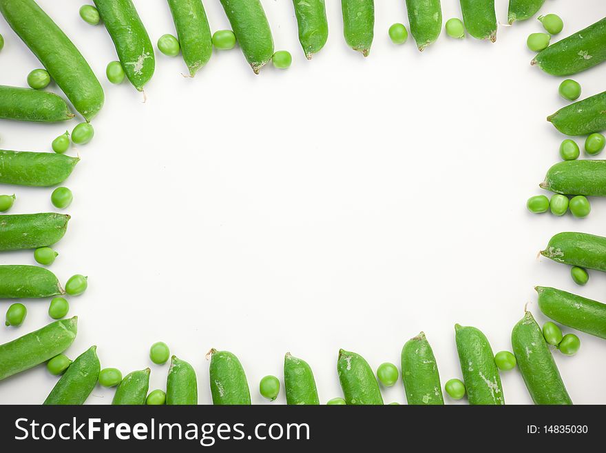 Frame of green peas on white background