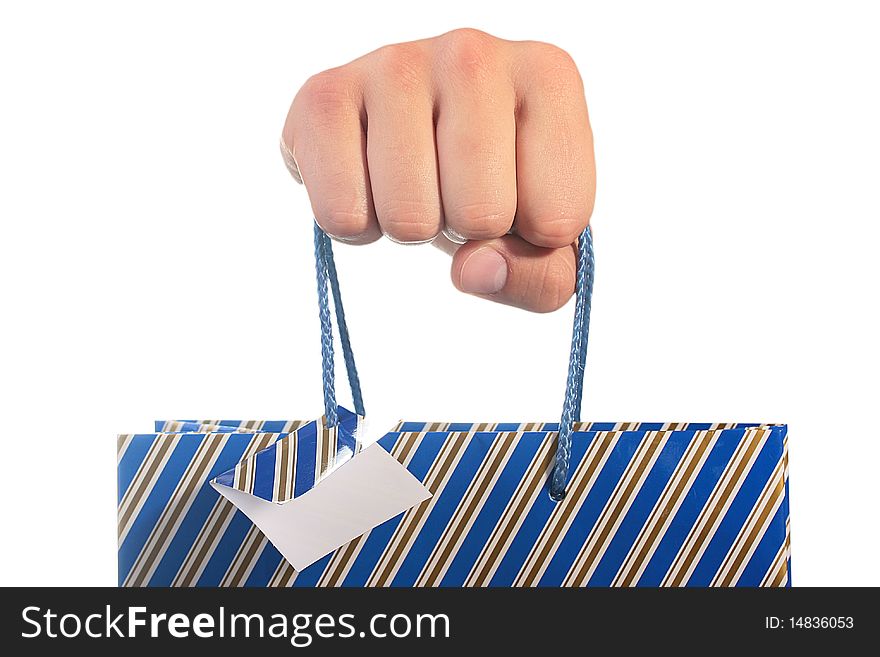 The man's hand holds a cardboard package for gifts. The man's hand holds a cardboard package for gifts.
