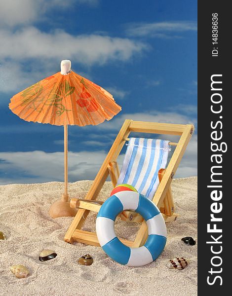 Deck chair and sun umbrella on a sandy beach. Deck chair and sun umbrella on a sandy beach