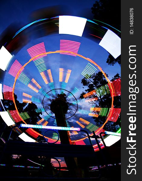 Ferris wheel in amusement park, blurred lights, night view. Ferris wheel in amusement park, blurred lights, night view