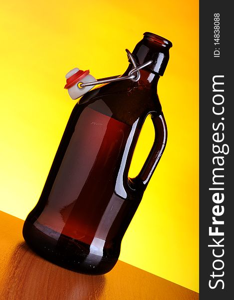 Old beer bottle on yellow background