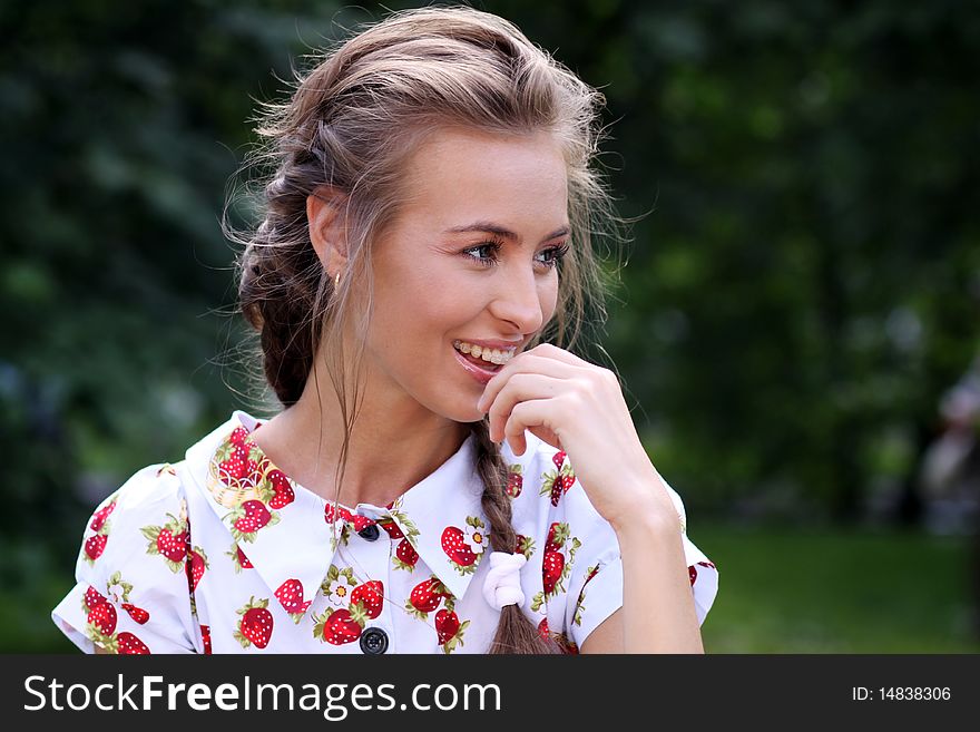 Portrait of the beautiful girl with a strawberry