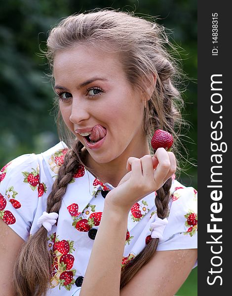 Portrait of the beautiful girl with a strawberry