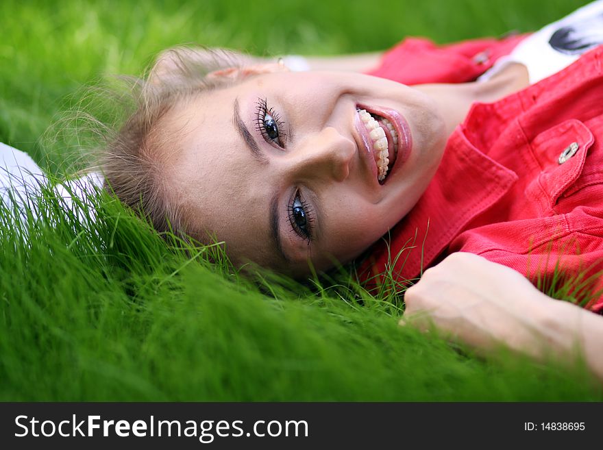 Cute young female lying on grass field at the park. Cute young female lying on grass field at the park