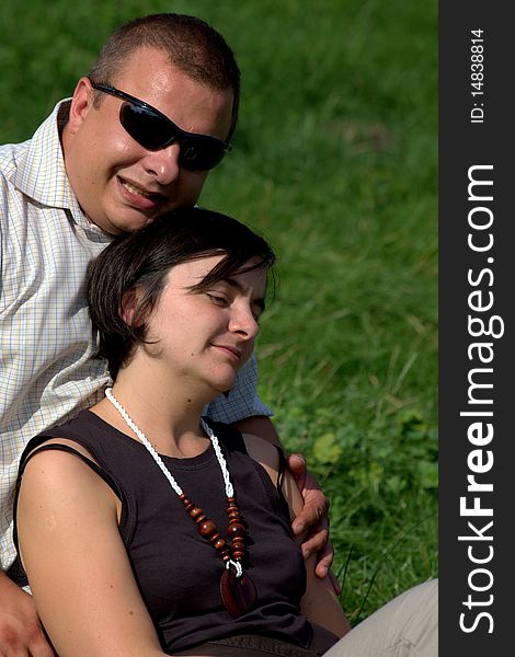 Couple sitting together on grass