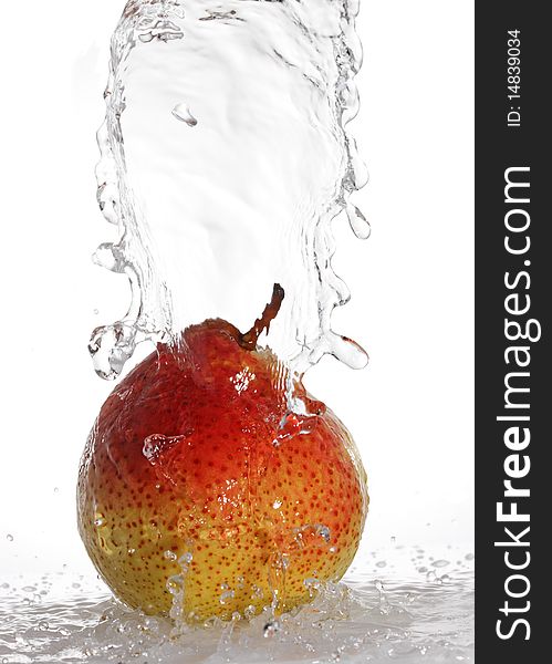 Water being poured on a pear isolated on white