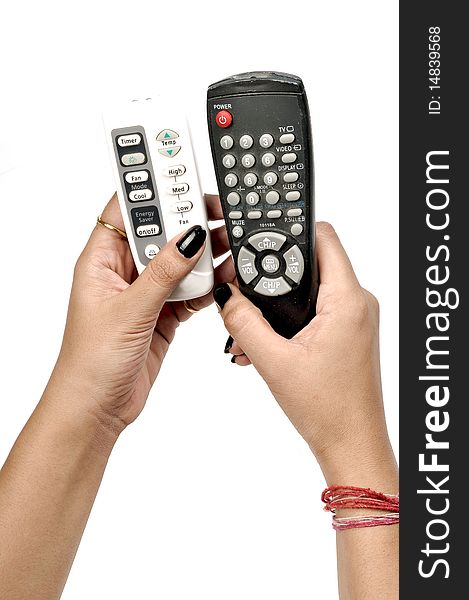 Female hand with two remotes isolated over white background. Female hand with two remotes isolated over white background.