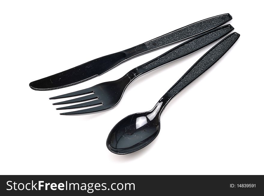 Black colored fork spoon and knife isolated over white background. Black colored fork spoon and knife isolated over white background.
