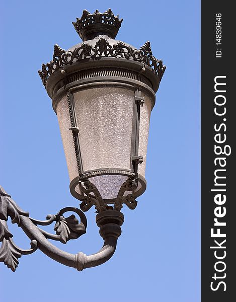 Old black street lamp against sky