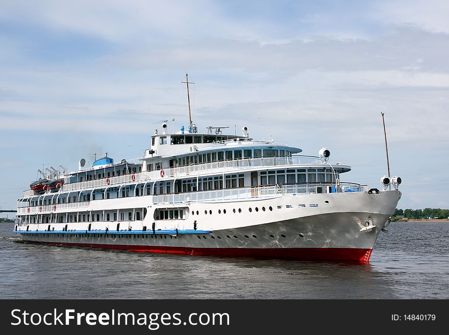 The white steamship floats on the river