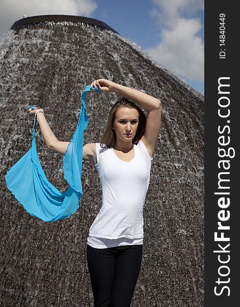 A woman holding her sarong next to her head with a serious expression on  her face. A woman holding her sarong next to her head with a serious expression on  her face.