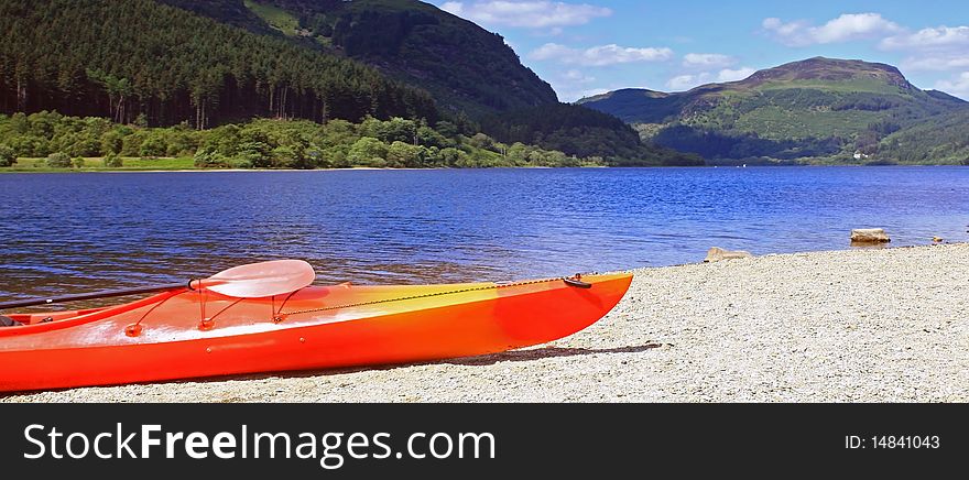 Scenic view of loch lubnaig in scotland  on a warm summers day with a canoe in the foreground. Scenic view of loch lubnaig in scotland  on a warm summers day with a canoe in the foreground