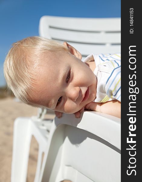 Smiling little boy lying in beach chair. Smiling little boy lying in beach chair