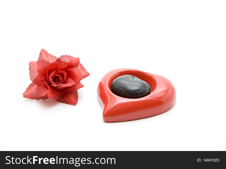 Red rose blossoms with ceramics heart. Red rose blossoms with ceramics heart